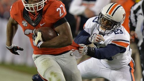 Auburn Tigers defensive back Johnathan Ford tries to pull down Georgia Bulldogs running back Nick Chubb by his shirt tail during the second half on Saturday, Nov. 15, 2014.