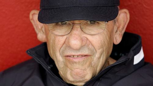 FILE - In this March 6, 2008, file photo, New York Yankees hall of fame catcher Yogi Berra watches spring training baseball action against the Cincinnati Reds in Sarasota, Fla. The Hall of Fame catcher renowned as much for his lovable, linguistically dizzying "Yogi-isms" as his unmatched 10 World Series championships with the Yankees, died Tuesday, Sept. 22, 2015. He was 90. (AP Photo/Gene J. Puskar, File)