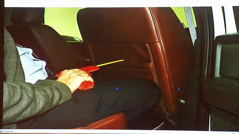 This photo shown to the court, using a model and a fake gun, shows a possible trajectory of the bullet that left Tex McIver's gun and entered the seat in front of him where Diane sat. The photo was part of witness Ross Martin Gardner's testimony in Tex McIver's murder trial on April 13, 2018 at the Fulton County Courthouse. (Channel 2 Action News)