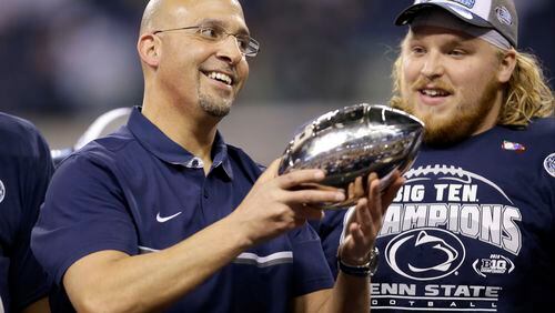 Penn State head coach James Franklin holds the trophy after defeating Wisconsin to with the Big Ten championship NCAA college football game Sunday, Dec. 4, 2016, in Indianapolis. Penn State won 38-31. (AP Photo/AJ Mast)