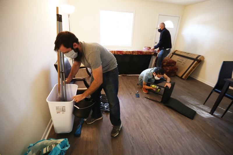 Members of the Welcome Co-Op prepare an apartment for a family of Afghan refugees. Miguel Martinez for The Atlanta Journal-Constitution 