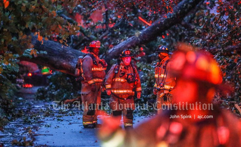 Atlanta fire crews assess the damage after a tree fell on a home on Iverson Street in the Candler Park neighborhood, causing a gas leak.