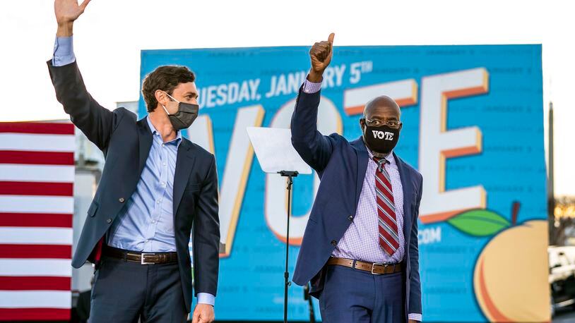 From left, Democratic Senate candidates Jon Ossoff and the Rev. Raphael Warnock wave after a campaign event with President-elect Joe Biden in Atlanta on Monday, Jan. 4, 2021. Their wins in runoff elections Tuesday gave Democrats control of the Senate. (Doug Mills/The New York Times)