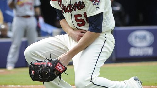 Braves reliever Dan Winkler collapses after fracturing his right elbow throwing a pitch in a game on April 10, 2016. (AP Photo/John Amis)
