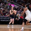 Indiana Fever's Caitlin Clark (22) puts up a 3-point shot in front of Atlanta Dream's Naz Hillmon during the second half of a WNBA preseason basketball game Thursday, May 9, 2024, in Indianapolis. (AP Photo/Darron Cummings)