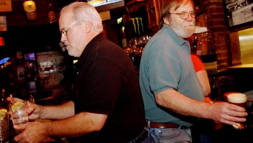 Bobby Agee (left) and Bill McCloskey serve customers at Manuel's Tavern in 2005. McCloskey, a fixture at Manuel’s for nearly 50 years, died Sunday, July 14, 2019.