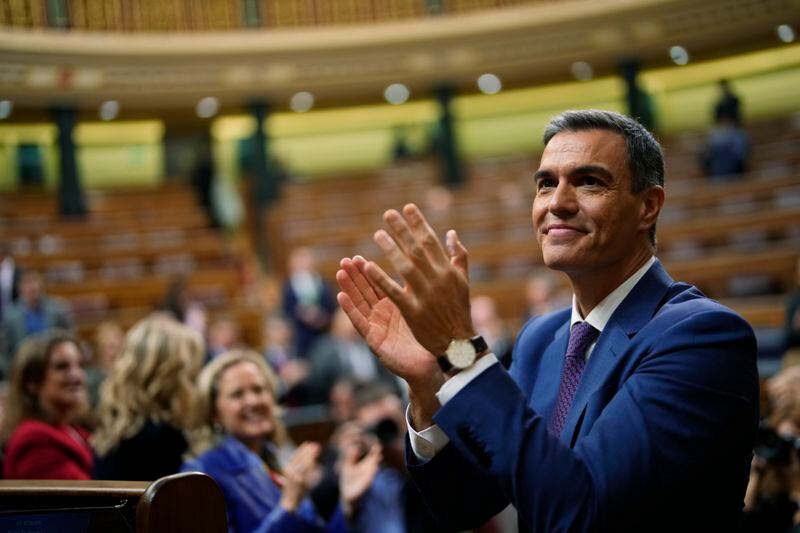 FILE, Spain's acting Prime Minister Pedro Sanchez applauds he was chosen by a majority of legislators to form a new government after a parliamentary vote at the Spanish Parliament in Madrid, Spain, Thursday, Nov. 16, 2023. Sánchez says he will continue in office "even with more strength" after days of reflection. Sánchez shocked the country last week when he said he was taking five days off to think about his future after a court opened preliminary proceedings against his wife on corruption allegations. (AP Photo/Manu Fernandez, File)