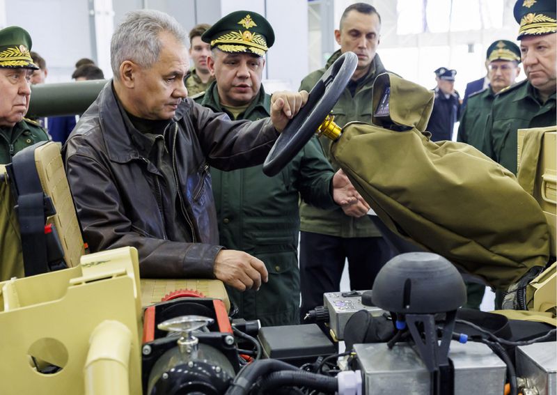 In this photo released by the Russian Defense Ministry Press Service on Wednesday, April 17, 2024, Russian Defense Minister Sergei Shoigu, foreground, visits an exhibition of the new scientific and technical developments in the logistics system of the Russian Armed Forces at the Patriot Convention and Exhibition Center outside Moscow, Russia. Shoigu checked the implementation of instructions on the development of robotic systems, advanced weapons systems, as well as support for military personnel. (Russian Defense Ministry Press Service via AP)