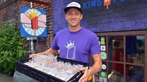 King of Pops co-owner Steven Carse holds a tray of frozen pops outside the company’s Inman Park production facility. The company announced Friday that the company is suspending production in South Carolina after the FDA found “serious violations” at its facility.
