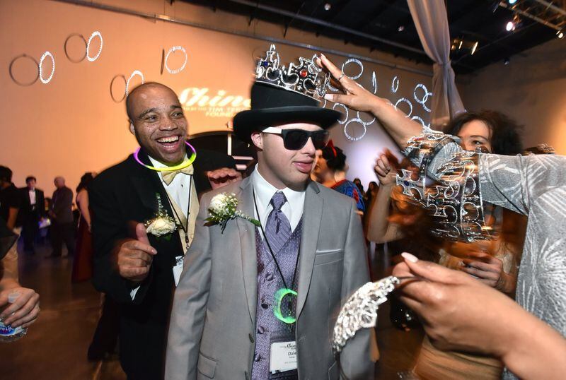 Dale Potter and Kelvin Gillespie (left) react while Potter is crowned by a volunteer during the “Night to Shine” event on Feb. 8 at First Baptist Church Atlanta in Dunwoody. More than 600 churches around the world, including First Baptist Church Atlanta, gave people with disabilities a prom night experience they won’t soon forget. HYOSUB SHIN / HSHIN@AJC.COM