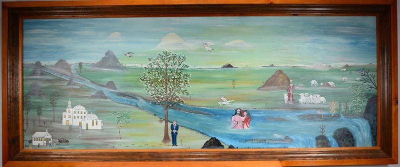“Chelsea Baptist Church,” an early painting by Howard Finster, will be auctioned on Saturday. This may be the largest Finster painting and has been housed for decades in a Chattooga County church the folk artist and minister once pastored.