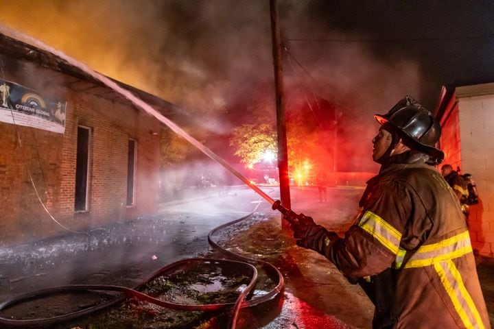 DeKalb County firefighters battle a blaze at the Celestial Citizens Global church on Richard Road Friday morning, April 19, 2024. No one was injured. The cause remains under investigation. (John Spink/AJC)