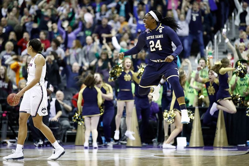 Notre Dame's Arike Ogunbowale (24) celebrates her game-winning basket with one second left in overtime against the Connecticut Huskies in the semifinals of the 2018 NCAA Women's Final Four March 20, 2018, at Nationwide Arena in Columbus, Ohio.
