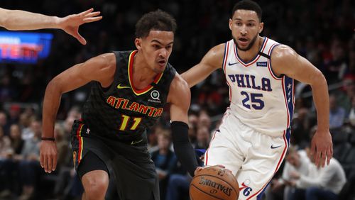 Hawks guard Trae Young (11) drives past Sixers guard Ben Simmons (25) during first half of an NBA basketball game Thursday, Jan. 30, 2020, in Atlanta.