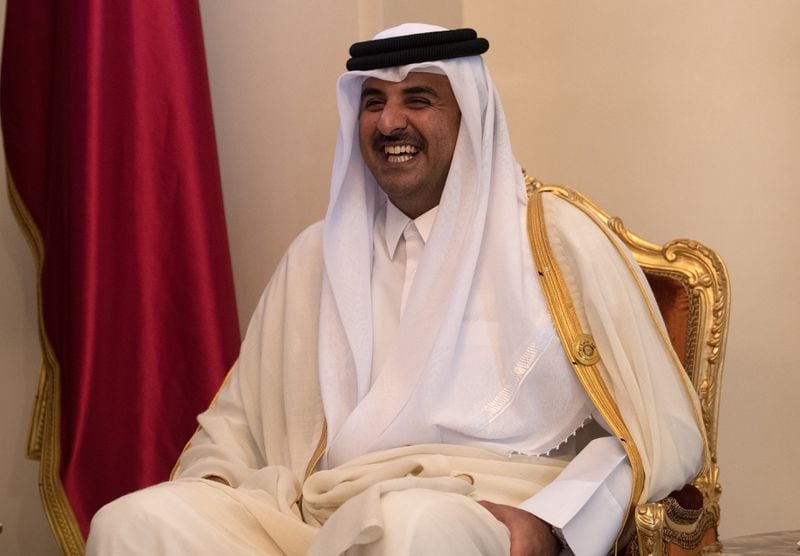 Sheikh Tamim bin Hamad Al Thani, the Emir of Qatar, smiles as he talks with British Prime Minister Theresa May during a bilateral meeting at the Gulf Cooperation Council summit, on December 7, 2016 in Manama, Bahrain.
