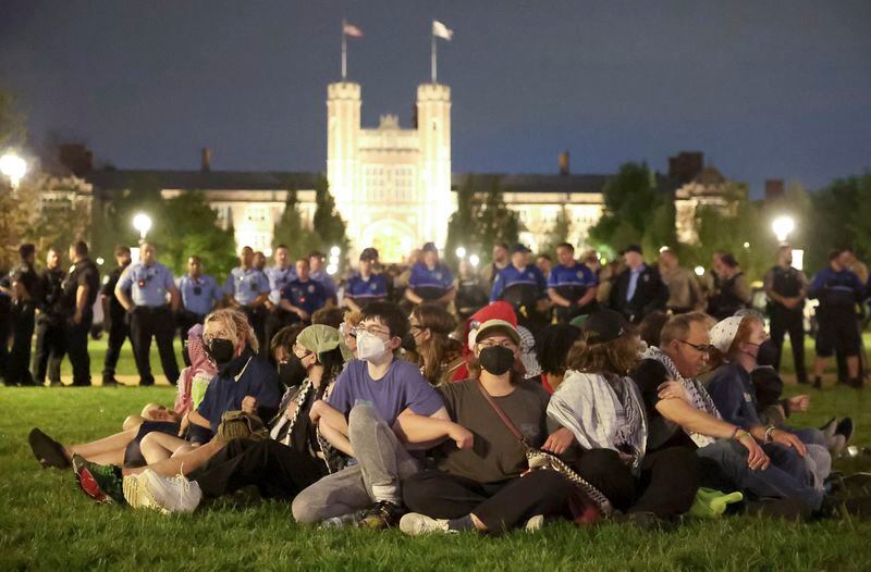 Protesters in support of Palestinians link arms as police prepare to arrest them on Washington University's campus in St. Louis, Saturday, April 27, 2024. (Christine Tannous/St. Louis Post-Dispatch via AP)