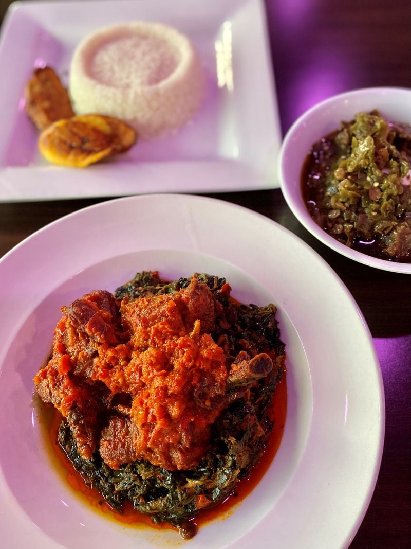 Among the Nigerian classics you can try at the Island Grill are ayamase stew (bottom) with plantains and rice; and efo riro, a thick green soup of amaranth greens, spicy pepper sauce and locust beans (right). Wendell Brock for The Atlanta Journal-Constitution