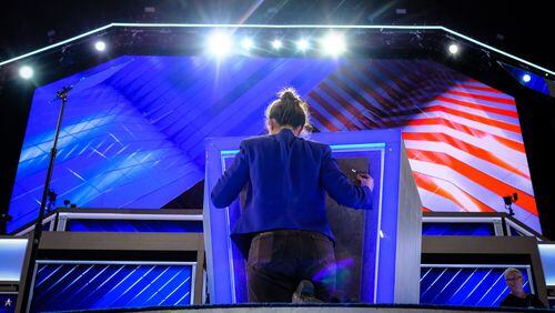 Final touches are made to the podium Sunday evening, July 24, 2016, as the Democratic National Convention prepares to kickoff on Monday in Philidelphia. (AP Photo/J. David Ake)