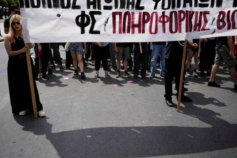 Protesters hold banners during a rally in Athens, Greece, Wednesday, April 17, 2024. A 24-hour strike called by Greece's largest labor union have halted ferries and public transport services in the Greek capital and other cities, to press for a return of collective bargaining rights axed more than a decade ago during a severe financial crisis. (AP Photo/Thanassis Stavrakis)