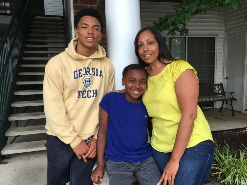Georgia Tech freshman A-back Dontae Smith outside his family's apartment in Spring Hill, Tenn., with his younger brother Seneca Caldwell and mother Desire’e Salazar. (AJC photo by Ken Sugiura)