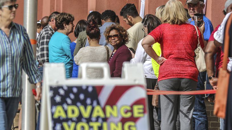 People lined up Thursday at the Cobb County West Park Government Center in Marietta for early voting. The Secretary of State’s Office said nearly 47,000 voter registrations are still pending because they were flagged as not complying with the state’s “exact match” law. JOHN SPINK/JSPINK@AJC.COM