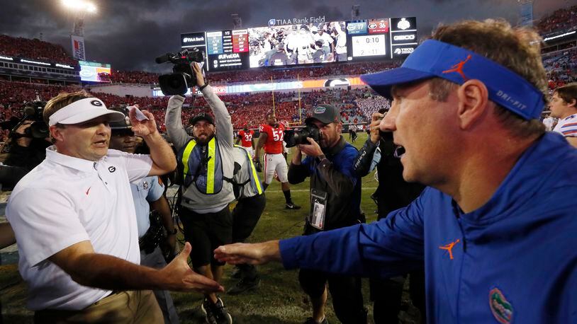 10/27/18 - Jacksonville - Georgia coach Kirby Smart is congratulated by Florida coach Dan Mullen after the victory.  The University of Georgia Bulldogs beat the Florida Gators 36-17 in a NCAA college football game Saturday, Oct. 27th, 2018, at TIAA Bank Field in Jacksonville, FL.      BOB ANDRES / BANDRES@AJC.COM