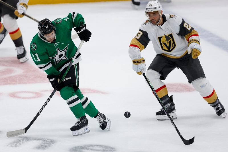 Dallas Stars center Logan Stankoven (11) skates against Vegas Golden Knights defenseman Alec Martinez (23) during the first period in Game 7 of an NHL hockey Stanley Cup first-round playoff series, Sunday, May 5, 2024, in Dallas. (AP Photo/Brandon Wade)