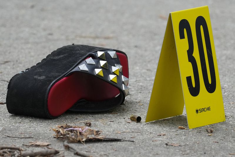 An evidence marker is place next to a cartridge case at the scene of a shooting at an Eid event in Philadelphia, Wednesday, April 10, 2024. (AP Photo/Matt Rourke)