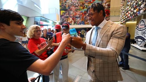 Georgia linebacker Nolan Smith gives a Georgia fan a fist bump as he arrives for SEC Media Days in the College Football Hall of Fame on Wednesday, July 20, 2022, in Atlanta.   “Curtis Compton / Curtis Compton@ajc.com”