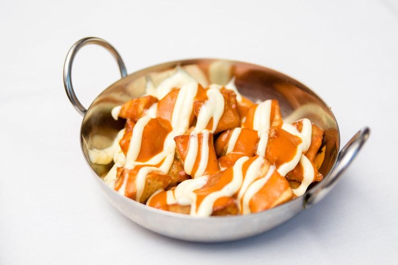 Patatas bravas, a classic combination of crunchy potatoes and spicy aioli, is a traditional Spanish tapa available at Bulla in Midtown. CONTRIBUTED BY HENRI HOLLIS
