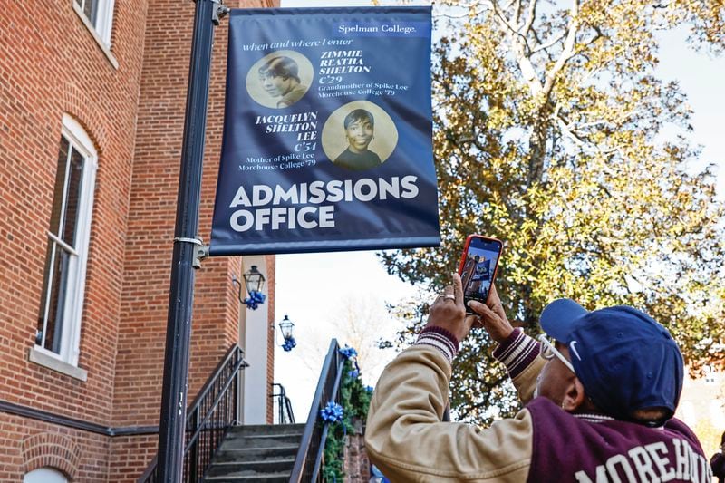 Film director Spike Lee takes a photo of signage for the admissions office dedicated to his mother and grandmother at Spelman College on Monday, November 28, 2022. (Natrice Miller/natrice.miller@ajc.com)  