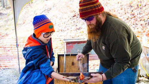 Devan Cole (right) works with a young person as part of one of his glass blowing workshops. Cole will hold similar workshops at Brickworks Gallery this month and next, and his art will be exhibited there as well. CONTRIBUTED BY BRICKWORKS GALLERY