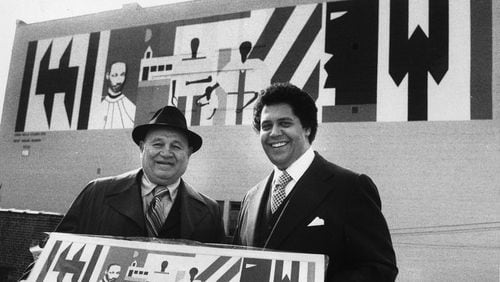 Mayor Maynard Jackson poses with artist Romare Bearden in front of a new mural by Bearden in downtown Atlanta. The mural, since demolished, was commissioned by the Urban Walls Project, in hand with the Arts Festival of Atlanta and Central Atlanta Progress. Jackson made the promotion of arts and culture a key part of his administration's legacy. (Billy Downs/AJC 1976 photo)