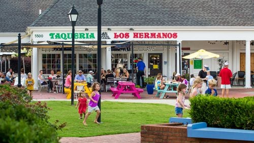 Dunwoody Village businesses, including Taqueria Los Hermonos in The Shops of Dunwoody strip mall, may soon have a new city center, in the mean time the locals enjoy whatever green space and outdoor patios they can find in the multiple shopping complexes, patched together in the area on Thursday, July 22, 2021.  (Jenni Girtman for The Atlanta Journal-Constitution)