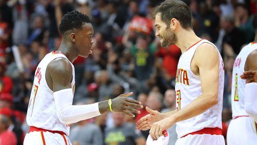 Atlanta Hawks’ Dennis Schroder and Jose Calderon celebrate during a 111-101 victory over the Washington Wizards in Game 4 of a first-round NBA basketball playoff series on Monday, April 24, 2017, in Atlanta. Curtis Compton/ccompton@ajc.com