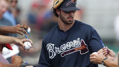 Dansby Swanson signs autographs before a spring training road game in Jupiter, Fla. The only rookie on the Braves’ opening-day roster is already one of the team’s most recognizable and popular players in recent years. (AP Photo)