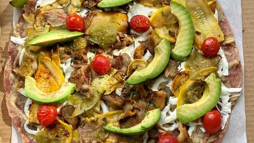 Gato chef Nicholas Stinson’s vegetarian tlayuda comes with mushrooms, summer squash, avocado, cherry tomatoes, bean puree, Oaxacan string cheese and salsa amarillo verde, all on a crispy red tortilla. Wendell Brock for The Atlanta Journal-Constitution
