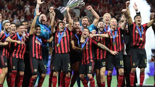 August 27, 2019 Atlanta: Atlanta United players hoist the Lamar Hunt Trophy after defeating Minnesota United 2-1 to win the U.S. Open Cup on Tuesday, August 27, 2019, in Atlanta.  Curtis Compton/ccompton@ajc.com
