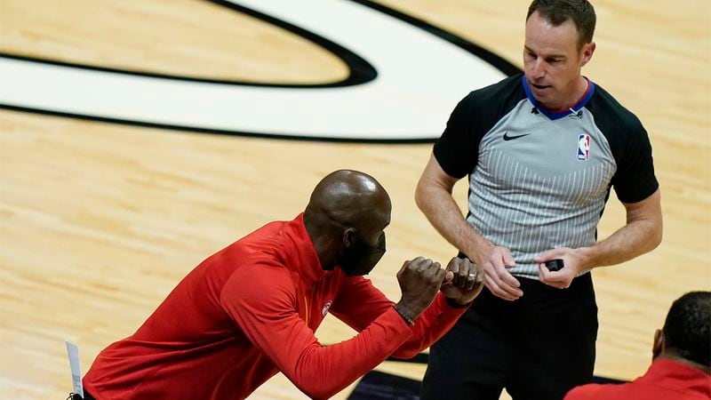 Atlanta Hawks head coach Lloyd Pierce (left) makes a point with official Josh Tiven during the second half against the Miami Heat, Sunday, Feb. 28, 2021, in Miami. (Lynne Sladky/AP)