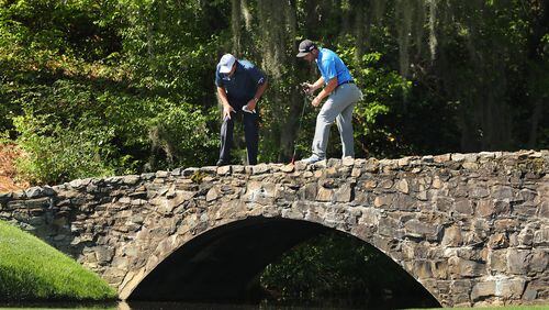 Phil Mickelson and Jon Rahm pause on the bridge to look into the creek along the 13th fairway during their practice round for the Masters at Augusta National Golf Club on Tuesday, April 4, 2017, in Augusta. Curtis Compton/ccompton@ajc.com