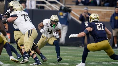 Georgia Tech's Dontae Smith (4) runs against Notre Dame's JD Bertrand (27) during the first half of an NCAA college football game, Saturday, Nov. 20, 2021, in South Bend, Ind. (AP Photo/Darron Cummings)