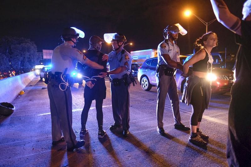 Demonstrators are detained. Protesters had shut down the interstate near an Atlanta Wendy's on Saturday, June 13, 2020, in response to the death of Rayshard Brooks, a black man who was shot and killed by Atlanta police Friday evening following a struggle in a Wendy's drive-thru line. (Photo: Ben Gray for The Atlanta Journal-Constitutiion)