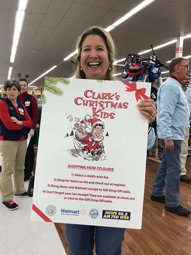 Clark's Kids volunteer Danielle Lambert was assigned to guide Wal-Mart shoppers at Dunwoody to the tables to pick the foster kids they wanted to sponsor. CREDIT: Rodney Ho/rho@ajc.com