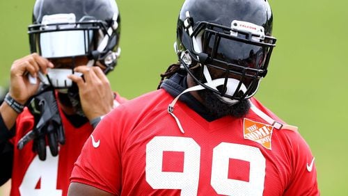 Atlanta Falcons defensive tackle Terrell McClain prepares to run a drill with Vic Beasley Jr. (background) during the final day of mandatory minicamp Thursday, June 14, 2018, in Flowery Branch.