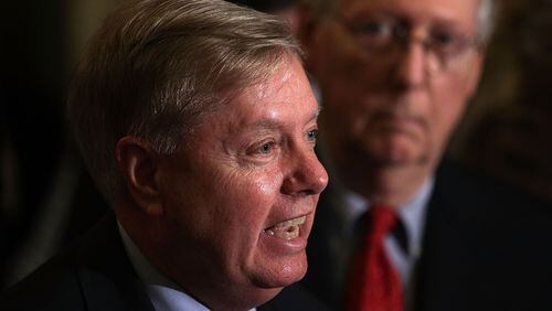 Sen. Lindsey Graham speaks as Senate Majority Leader Sen. Mitch McConnell listens during a news briefing after the weekly Senate Republican policy luncheon at the Capitol September 19, 2017 in Washington, DC. Senate Republican held a weekly policy luncheon to discuss GOP agenda. (Photo by Alex Wong/Getty Images)