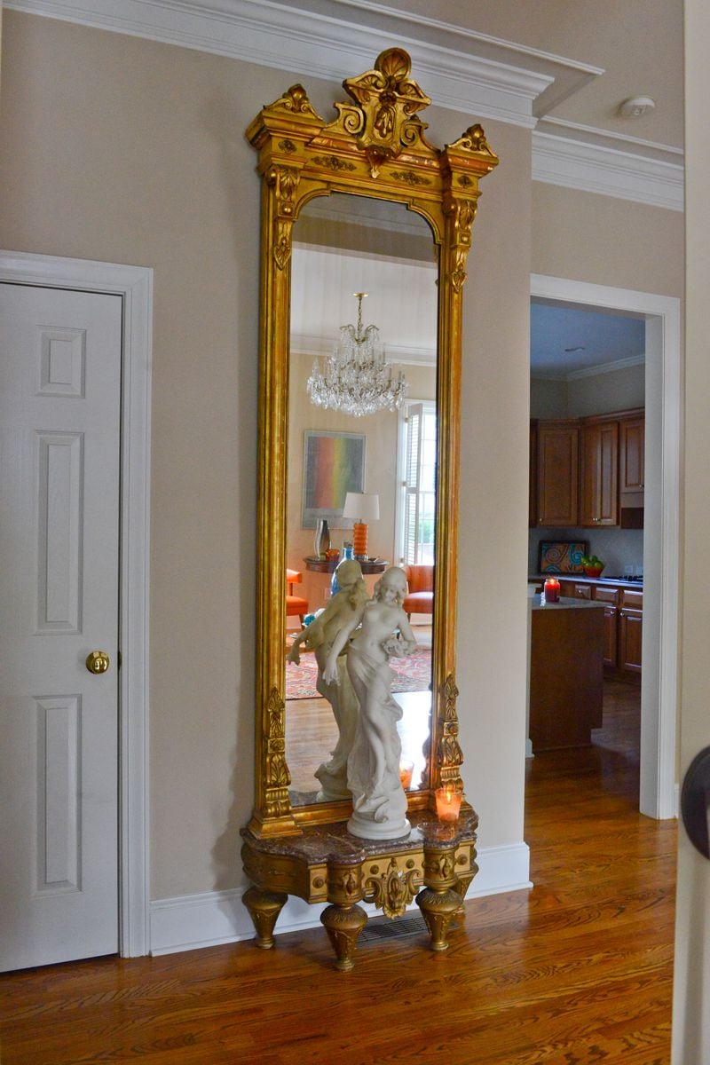 "My favorite piece of furniture is an 1880s 10-foot high Renaissance Revival pier mirror, purchased at an estate sale in Stone Mountain," says homeowner Pedro Ayestaran Diaz. "I love the majesty of its size." At the base of the mirror is a 1900s art nouveau statue made of Carrara marble, signed A. Batacchi/Florence, found at Fontaine's Auction Gallery in Massachusetts. Text by Lori Johnston and Keith Still/Fast Copy News Service. (Christopher Oquendo Photography/www.ophotography.com)
