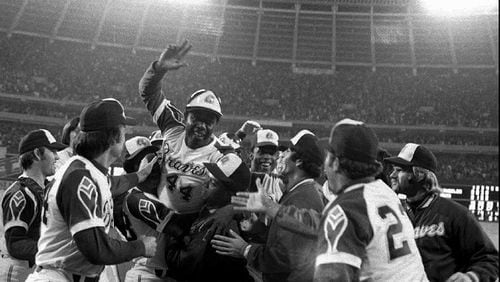 Braves slugger Hank Aaron is welcomed at home plate after smashing his 715th career home run - breaking Babe Ruth's record on April 8, 1974, at Atlanta-Fulton County Stadium.  (AP Photo/File)