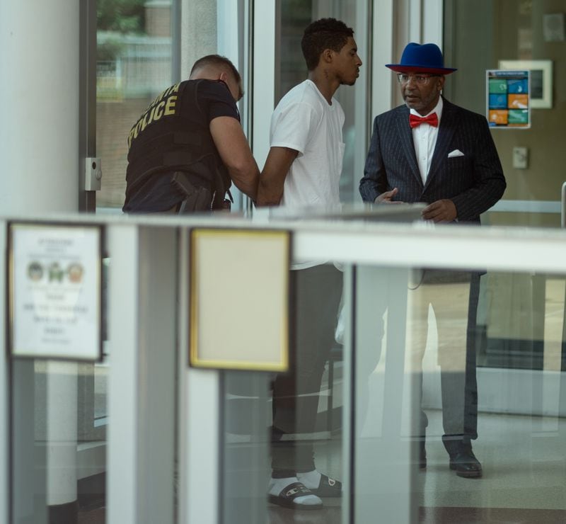 Julian Conley, who is accused of felony murder in the shooting death of 8-year-old Secoriea Turner, talks to his attorney as he is handcuffed after turning himself in to Atlanta Police Wednesday afternoon July 15, 2020. (Ben Gray for The Atlanta Journal-Constitution)