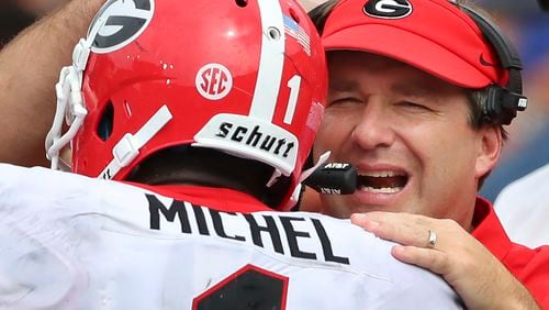 Georgia head coach Kirby Smart gives tailback Sony Michel a pat on the helmet after his long touchdown run against Vanderbilt in the second half of an NCAA college football game on Saturday, Oct. 7, 2017, in Nashville. Fifth-ranked Georgia routed Vanderbilt 45-14. (Curtis Compton/Atlanta Journal-Constitution via AP)
