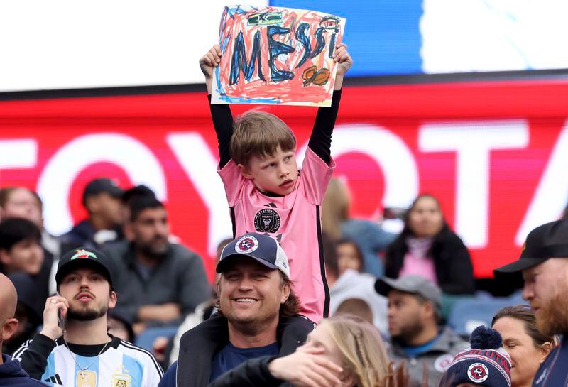 A young fan shows his support for Inter Miami forward Lionel Messi before an MLS soccer match against the New England Revolution, Saturday, April 27, 2024, in Foxborough, Mass. (AP Photo/Mark Stockwell)